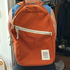 Medium sized back pack, brick color exterior w black interior.